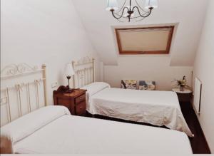 A bed or beds in a room at Ático al lado del mar,en las rías baixas