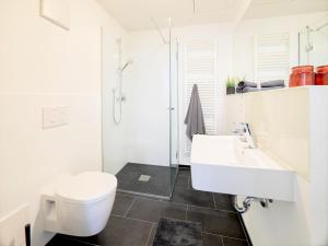 a white bathroom with a toilet and a sink at ☆Design Apartment Zentral☆200m vom Marktplatz☆ruhige Altstadtlage☆ in Reutlingen