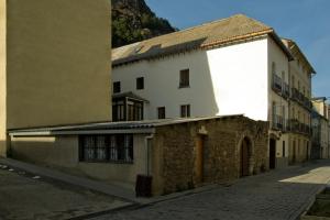 an old building in the middle of a street at Albergue-Refugio Sargantana in Canfranc