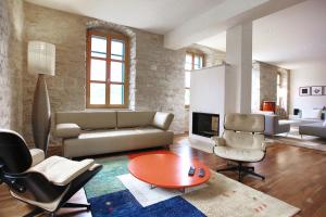 a living room with a couch and a table and chairs at Private luxury Villa del Mar on Solta for up to 10 persons, heated pool, free parking, next to sea! FREE Kajak & Mountainbikes, GREAT living area & privacy! in Rogač