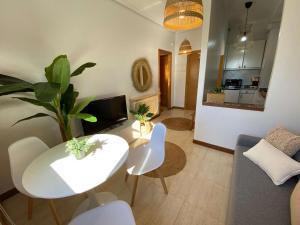 a living room with a white table and white chairs at Samil55 in Vigo