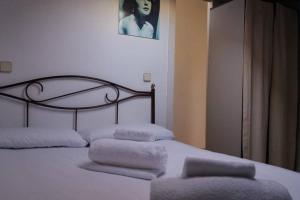 a bedroom with a bed with two pillows on it at COZY ROMANTIC MALASAÑA in Madrid