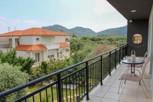 a balcony with a table and chairs and a view at Mirador Apartments in Limenas