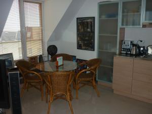 a dining room with a table and chairs and a kitchen at Апартмент Blue Sky in Sveti Vlas
