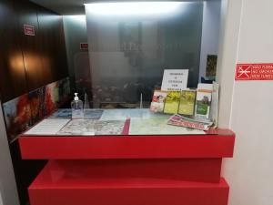 a red counter with books on top of it at Hotel Dom Joao IV in Guimarães
