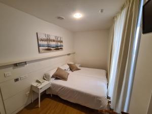 Postel nebo postele na pokoji v ubytování Hotel Jacobeo