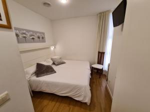 Postel nebo postele na pokoji v ubytování Hotel Jacobeo