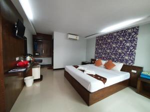 a bedroom with a large bed in a room at Ibiza Phi Phi in Phi Phi Don