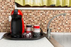 a coffee maker on a tray next to a kitchen sink at Anastellar in Kissamos +135 photos