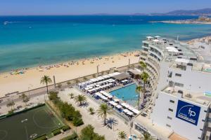 a large body of water with palm trees at Aparthotel Fontanellas Playa in Playa de Palma