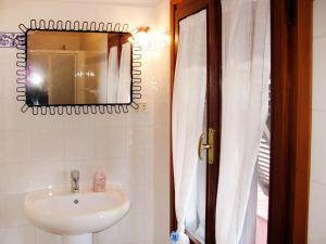 a bathroom with a sink and a mirror at Apartment Il Seccione-1 by Interhome in Portoferraio +13 photos