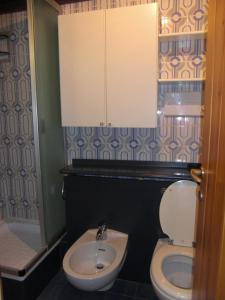 a bathroom with a toilet and a sink at Bilocale Alberti - Silvana in Madonna di Campiglio