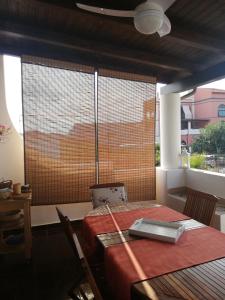 a dining room with a table and a window at Villetta Aurora in Lipari