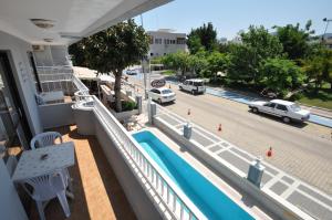 a balcony with a swimming pool and a street at Defne & Zevkim Hotel in Marmaris
