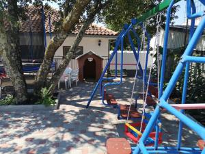 a playground with a blue swing set in a yard at Ivanka 2 in Selce