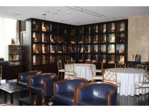 a dining room with tables and chairs and shelves at Mizusawa Ground Hotel - Vacation STAY 84949 in Oshu +3 photos