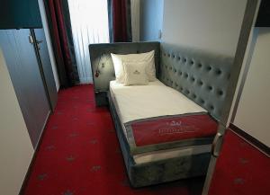 Postel nebo postele na pokoji v ubytování Hotel Royal