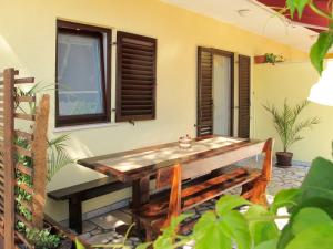 a wooden table sitting on the side of a house at Apartment Banko - PUL408 by Interhome in Peroj