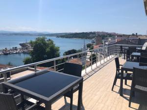 a balcony with tables and chairs and a view of the water at Sinopark Hotel in Sinop