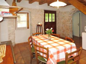 a kitchen and dining room with a table and chairs at Holiday Home Paolici - LBN337 by Interhome in Nedeščina