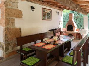 a dining room with a table and a fireplace at Holiday Home Paolici - LBN337 by Interhome in Nedeščina