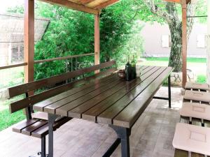 a wooden bench sitting on top of a patio at Holiday Home Verbanac - LBN351 by Interhome in Labin