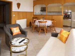 a living room with a table and chairs and a kitchen at Apartment Dani by Interhome in Labin