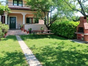 a house with a yard with a table and a grill at Holiday Home Andrea - LBN415 by Interhome in Labin
