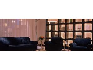 a living room with two couches and a table at Mizusawa Ground Hotel - Vacation STAY 84945 in Oshu +3 photos
