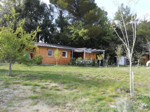 a small house in a yard with trees at Ô chalets de Provence in Suze-la-Rousse