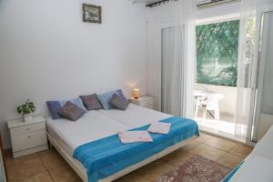 a bedroom with a bed and a large window at Apartments Butkovic in Hvar