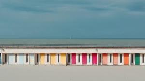 a building with different colored windows on the beach at Le Saint Amand, studio cabine, agréable terrasse sud in Le Touquet-Paris-Plage +9 photos