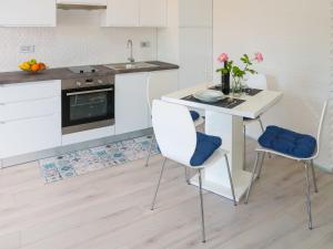 a kitchen with a white table and two chairs at Apartment Boris - RAC160 by Interhome in Raša