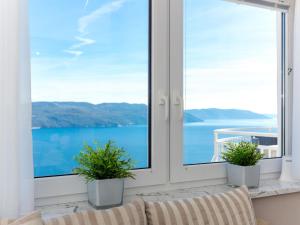 a room with a window with a view of the water at Holiday Home Casa Filip & Katja by Interhome in Plomin