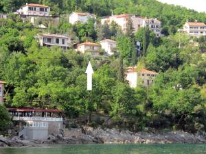 a view of a town from the water with a white arrow at Apartment Hela - LOV512 by Interhome in Opatija