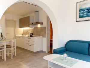 un soggiorno con divano blu e una cucina di Apartment Jurkovic - NJI100 by Interhome a Njivice