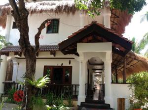 a large white house with a large window at Lanterna Hotel Boracay in Boracay
