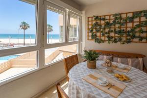 a dining room with a table with a view of the beach at BLUE Atlantic Family Home by Cadiz4Rentals in Cádiz