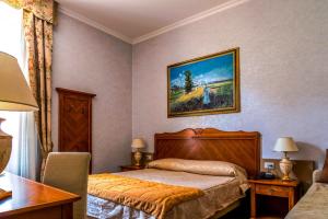 Postel nebo postele na pokoji v ubytování Hotel Maderno