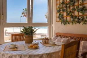 a table with a white table cloth and food on it at BLUE Atlantic Family Home by Cadiz4Rentals in Cádiz