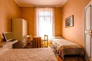 Postel nebo postele na pokoji v ubytování Hotel Maderno