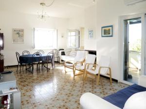 a living room with a table and chairs at Apartment Algamarina by Interhome in Cerveteri