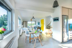 a kitchen and dining room with a table and chairs at Your Home2b in Paianía