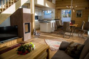 a large living room with a kitchen and a living room at Landhaus Alpenflora in Bolsterlang