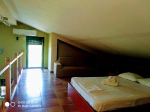 a bedroom with a bed and a couch at Vicente House in Skala Rachoniou