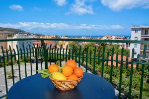 a basket of fruit sitting on a table on a balcony at Sunset Home Sorrento in Sorrento