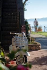 a vespa parked on the side of a house at Boutique Hotel Torre Di Cala Piccola in Porto Santo Stefano