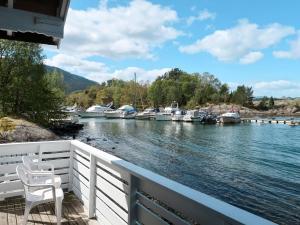 a balcony with a view of a marina with boats at Holiday Home Jokobu - FJH087 by Interhome in Skånevik