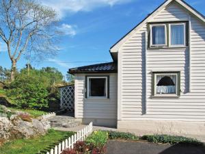 a white house with a window and a fence at Holiday Home Bjørkeneset by Interhome in Uggdal +19 photos