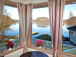 um quarto com uma grande janela com vista para um lago em Holiday Home Åptafjorden - SOW684 by Interhome em Farsund